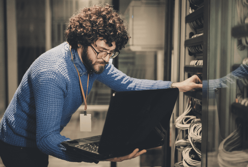 Man looking at computer screen in data centre